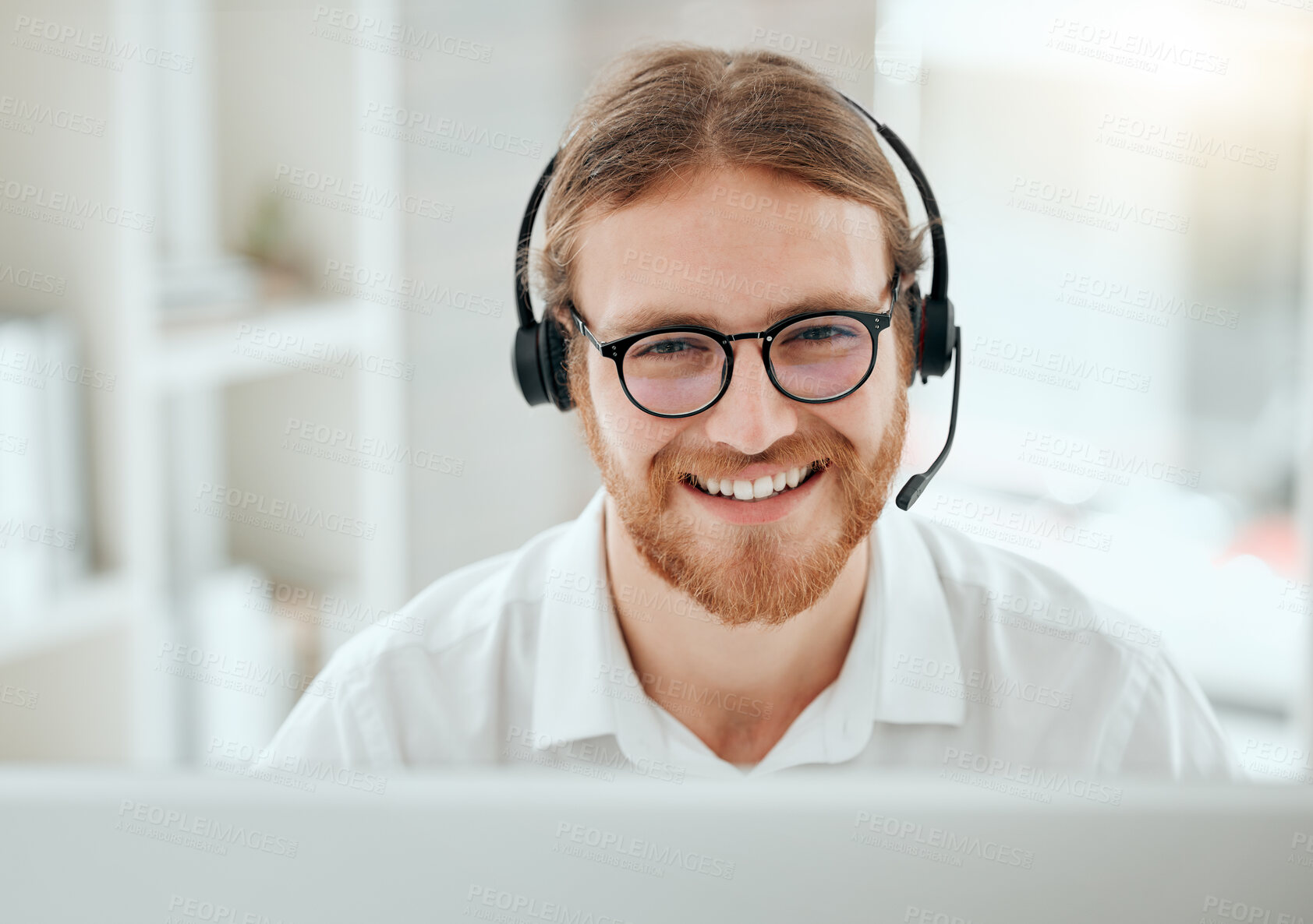 Buy stock photo Cropped shot of a handsome young male call center agent working at his desk in the office