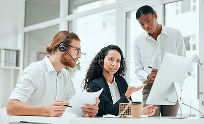 Buy stock photo Cropped shot of two young call center agent and their supervisor working in the office