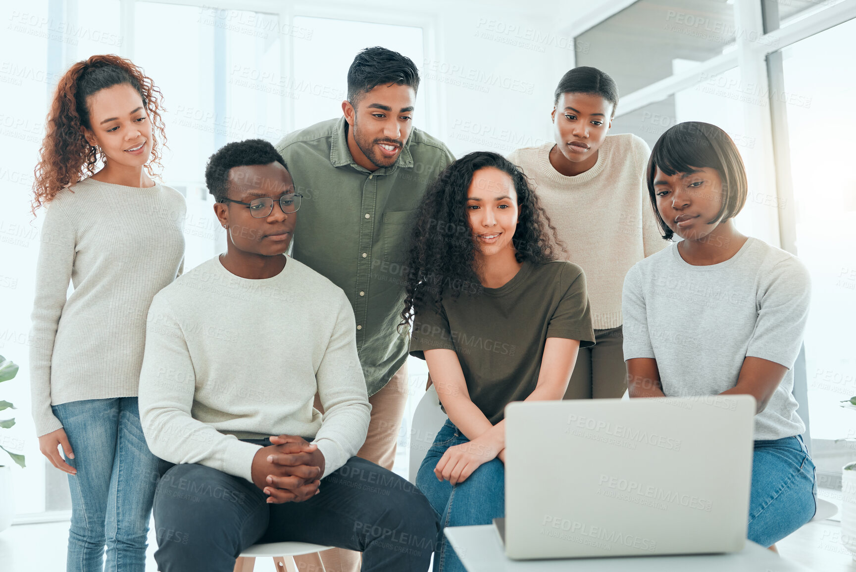 Buy stock photo Shot of a diverse group of people using a laptop during group therapy