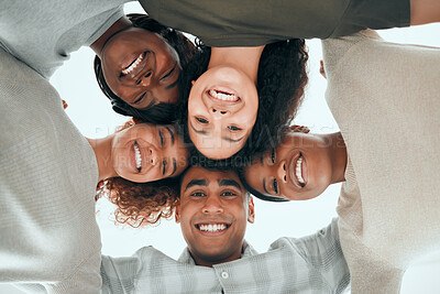 Buy stock photo Low angle shot of a diverse group of people standing huddled together after group therapy