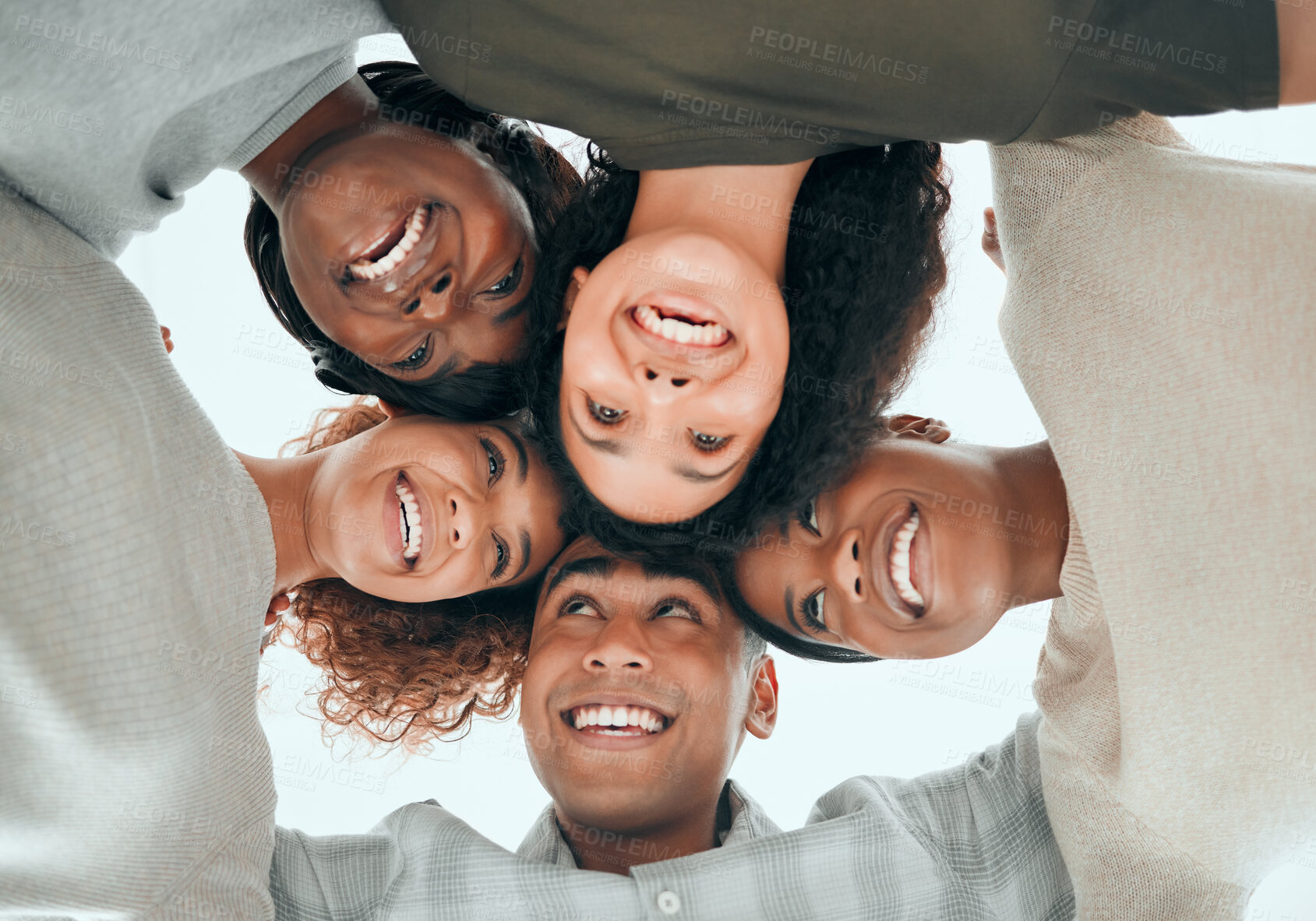 Buy stock photo Low angle, teamwork and business people with smile for hug, support and solidarity for creative agency. Office, diversity and happy designers with circle for cooperation, synergy and collaboration