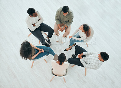 Buy stock photo High angle shot of an unrecognisable group of people sitting together and talking during therapy