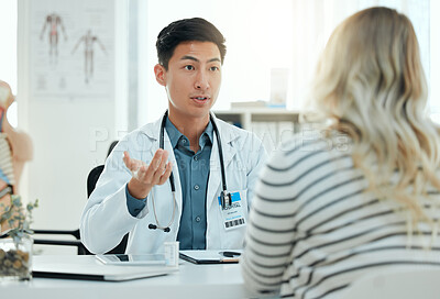 Buy stock photo Shot of a doctor during a consultation with a pregnant patient in a clinic