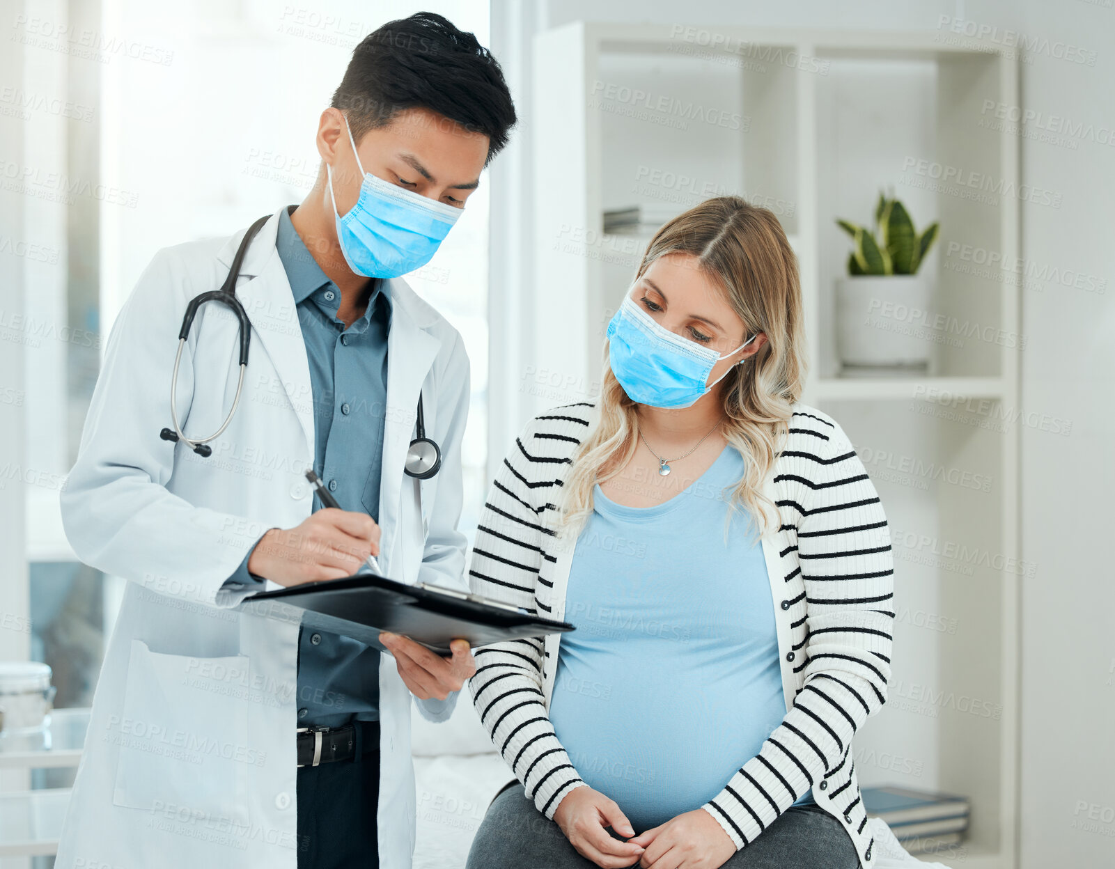 Buy stock photo Hospital, pregnant woman and doctor with information for checkup, appointment visit and tummy growth. Healthcare, patient or obstetrician with checklist for pregnancy, monitor wellness and face mask