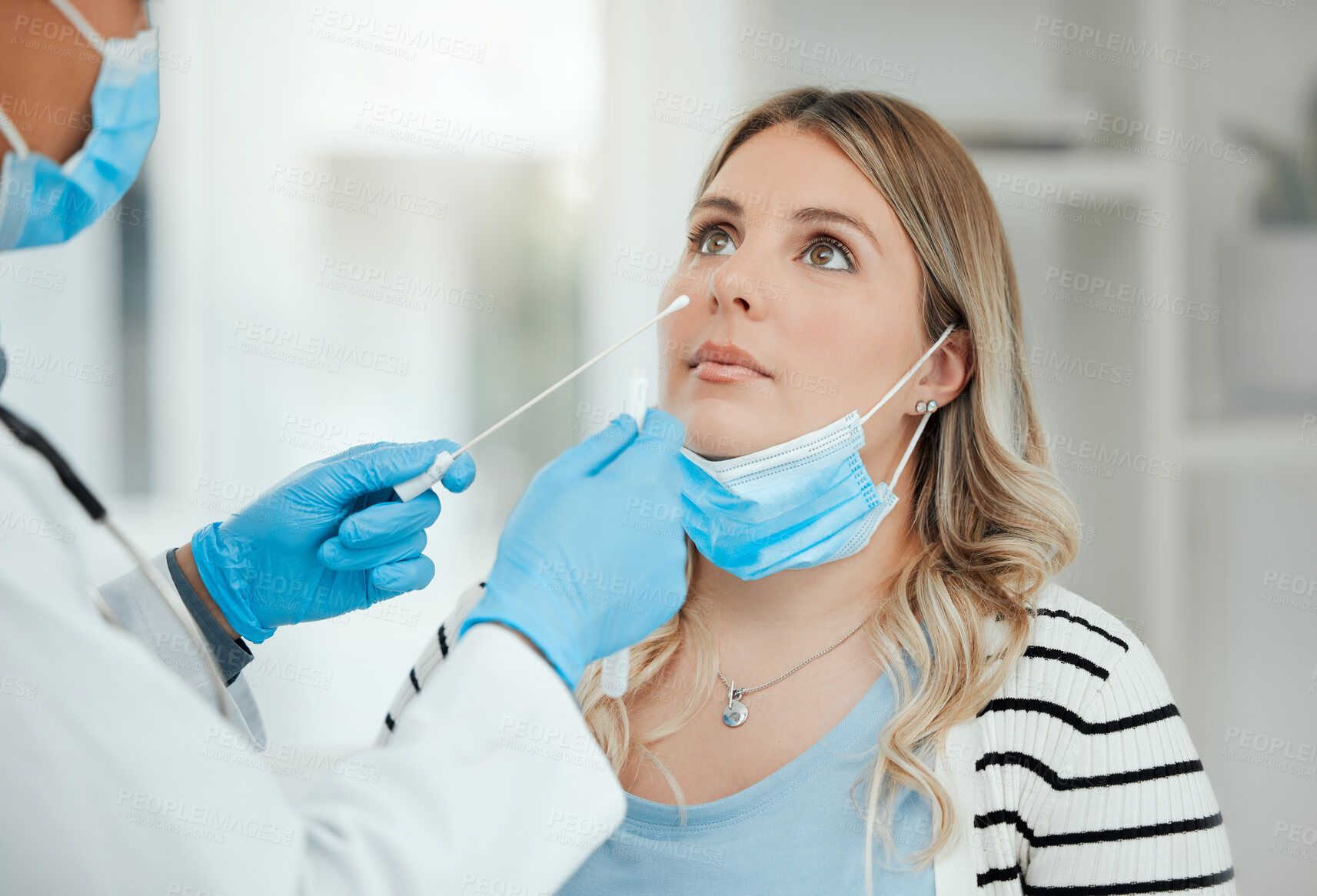Buy stock photo Shot of a doctor doing a nasal swab on a patient
