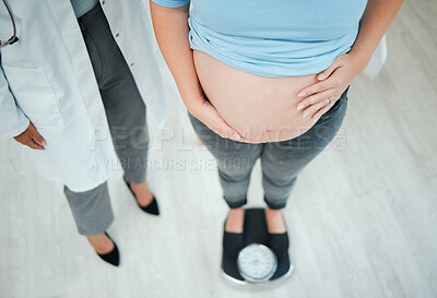 Buy stock photo Shot of a unrecognizable pregnant woman weighing herself in a clinic