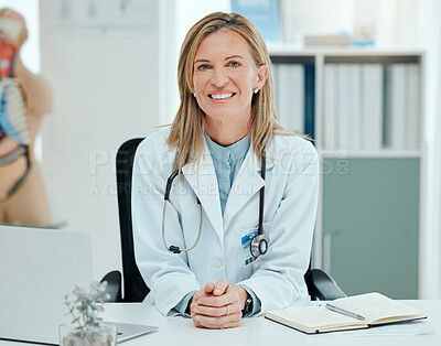 Buy stock photo Shot of a mature doctor sitting alone in her clinic