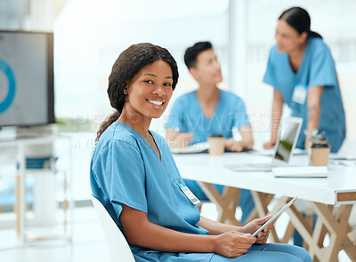 Buy stock photo Shot of a young female doctor using a digital tablet at a hospital