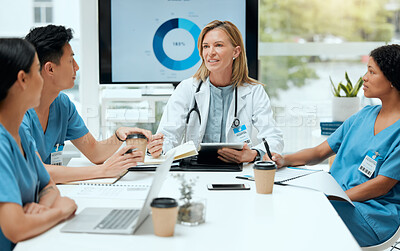 Buy stock photo Shot of a group of doctors in a meeting at a hospital