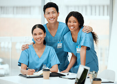 Buy stock photo Shot of a group of young doctors in a meeting at a hospital