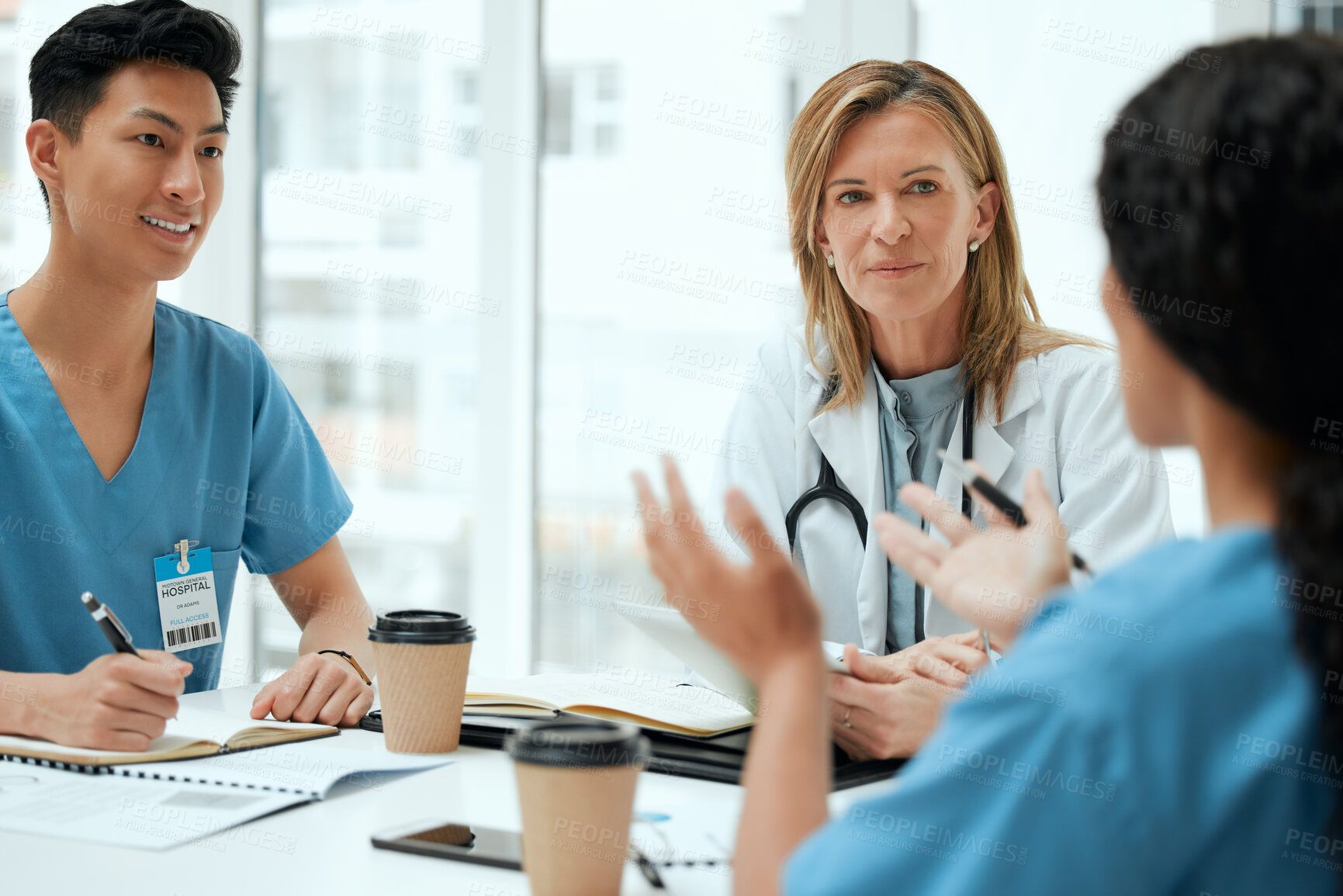 Buy stock photo Doctor, discussion and medical students with taking notes for healthcare, review or feedback. Group of people, talking and diversity in meeting in teamwork as staff for internship, clinic or hospital