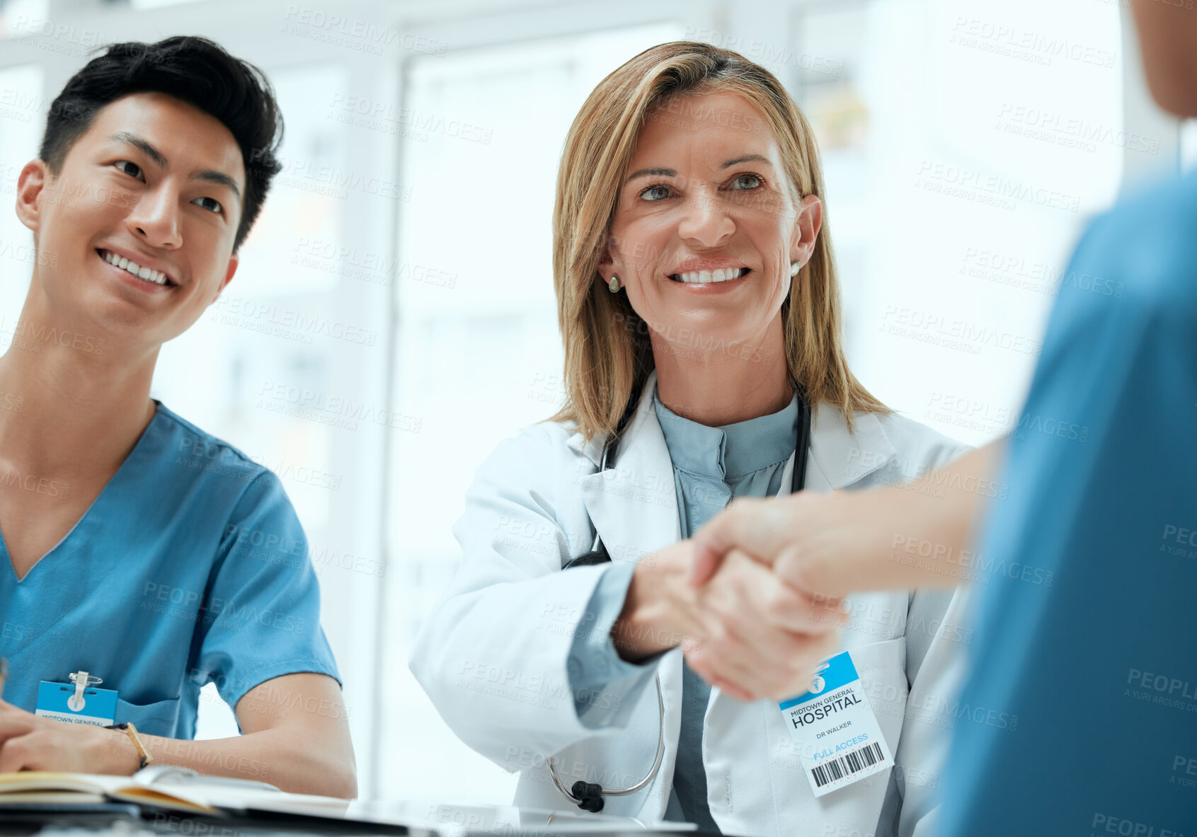 Buy stock photo People, doctor and nurse with hand shake at boardroom for welcome and congratulations on internship. Employees, office and happy or smile with greeting for job interview, opportunity and recruitment