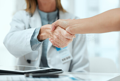 Buy stock photo Shot of two unrecognizable doctors shaking hands at a hospital