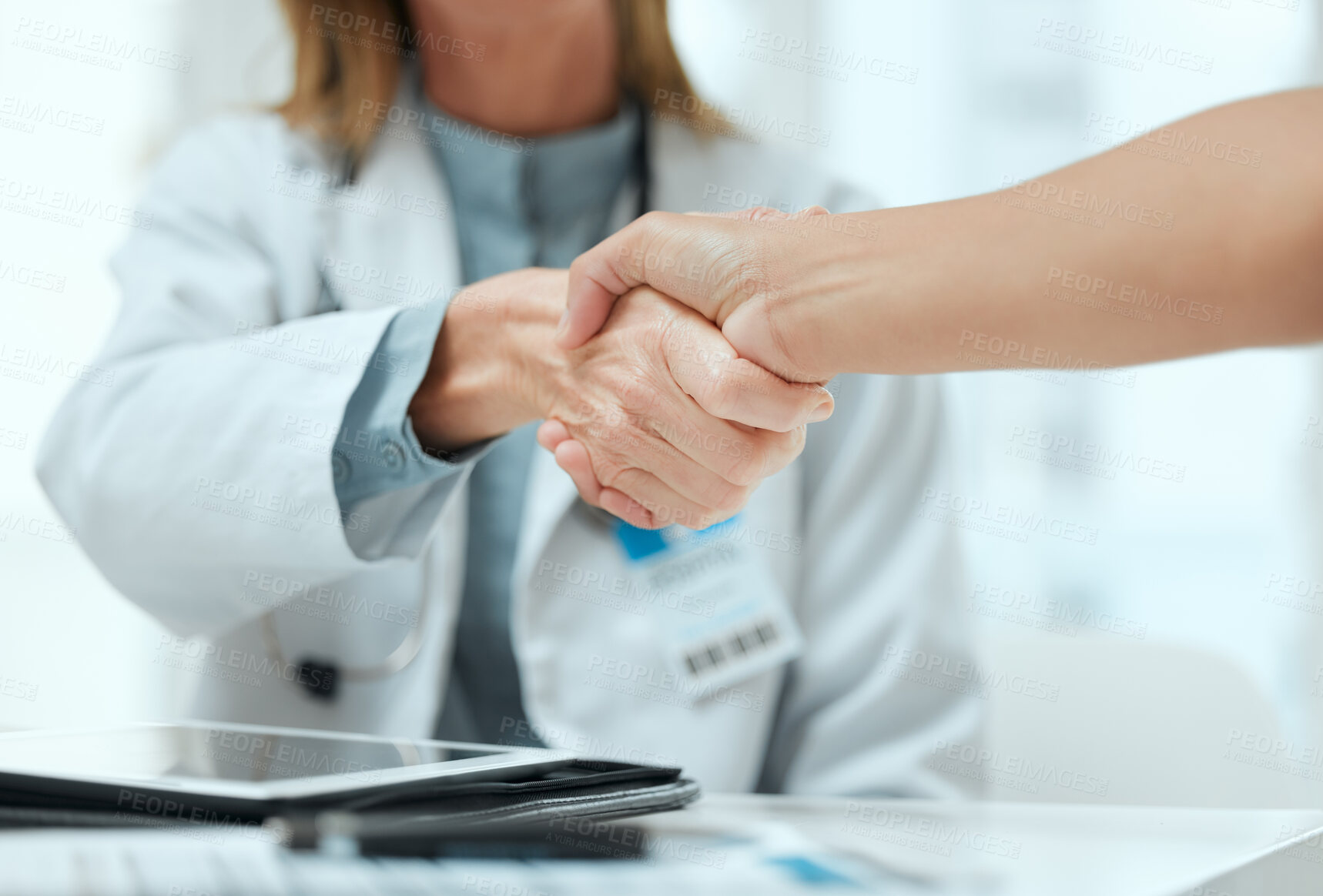 Buy stock photo Consulting, doctor and handshake with people in hospital office for medical agreement or meeting. Deal, interview or partnership with healthcare professional and patient shaking hands in clinic