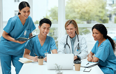 Buy stock photo Shot of a group of doctors in a meeting at a hospital
