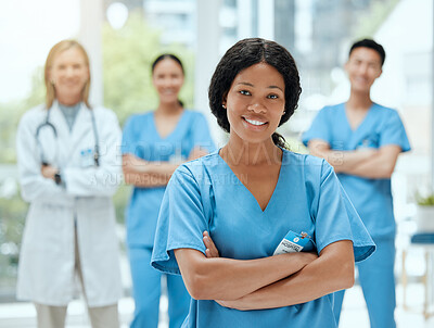 Buy stock photo Portrait, medicine and a black woman nurse arms crossed, standing with her team in a hospital for healthcare. Leadership, teamwork and a female health professional in a medical clinic for treatment