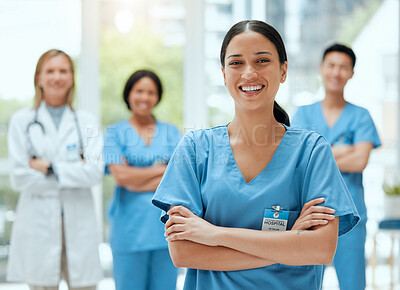 Buy stock photo Portrait, medical and a woman nurse arms crossed, standing with her team in the hospital for healthcare. Leadership, medicine and teamwork with a female health professional in a clinic for treatment