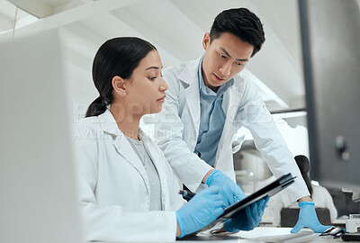 Buy stock photo Shot of two scientists collaborating in the lab