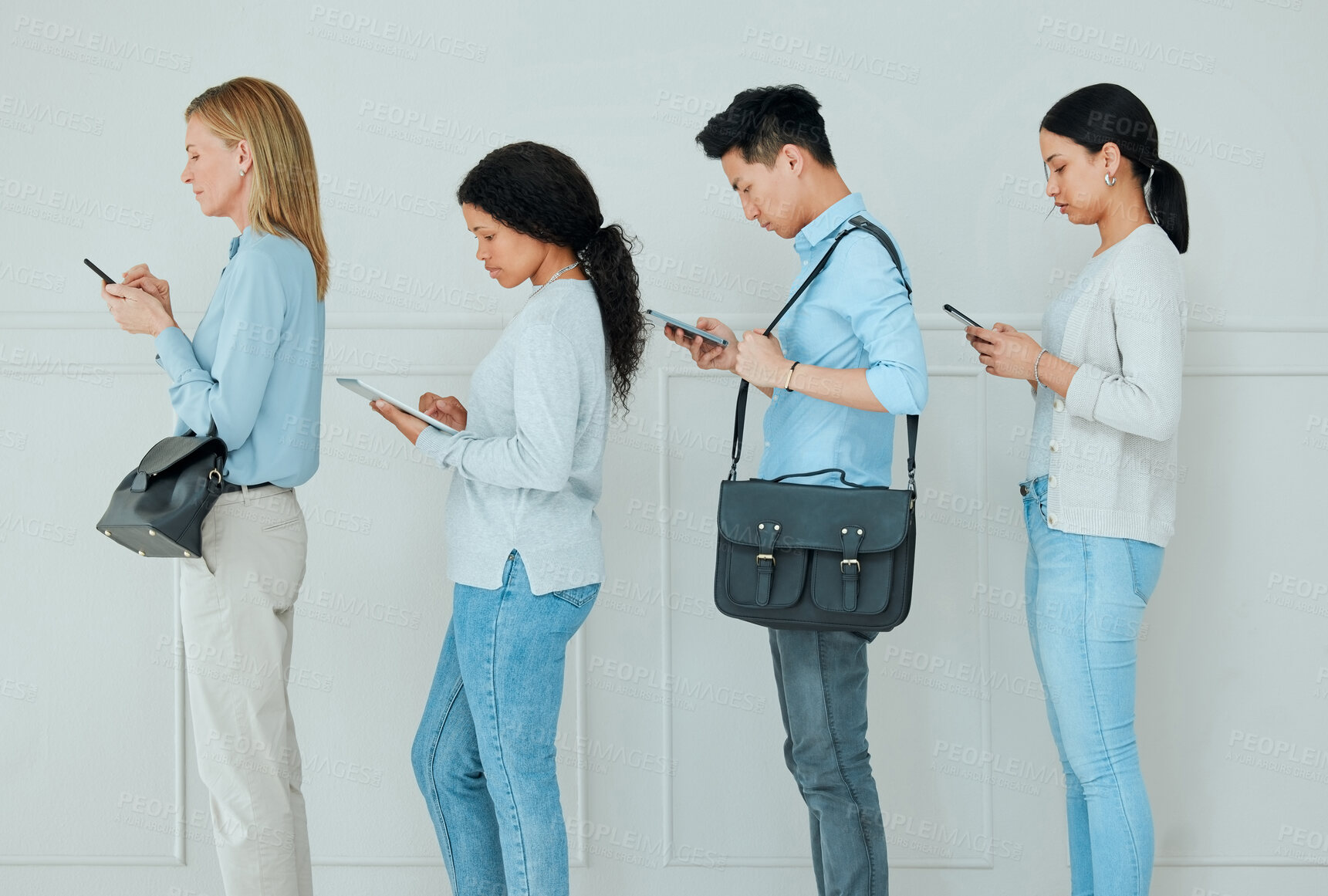 Buy stock photo Shot of a group of businesspeople standing in a line at an office