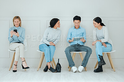 Buy stock photo Shot of a group of businesspeople waiting in line at an office