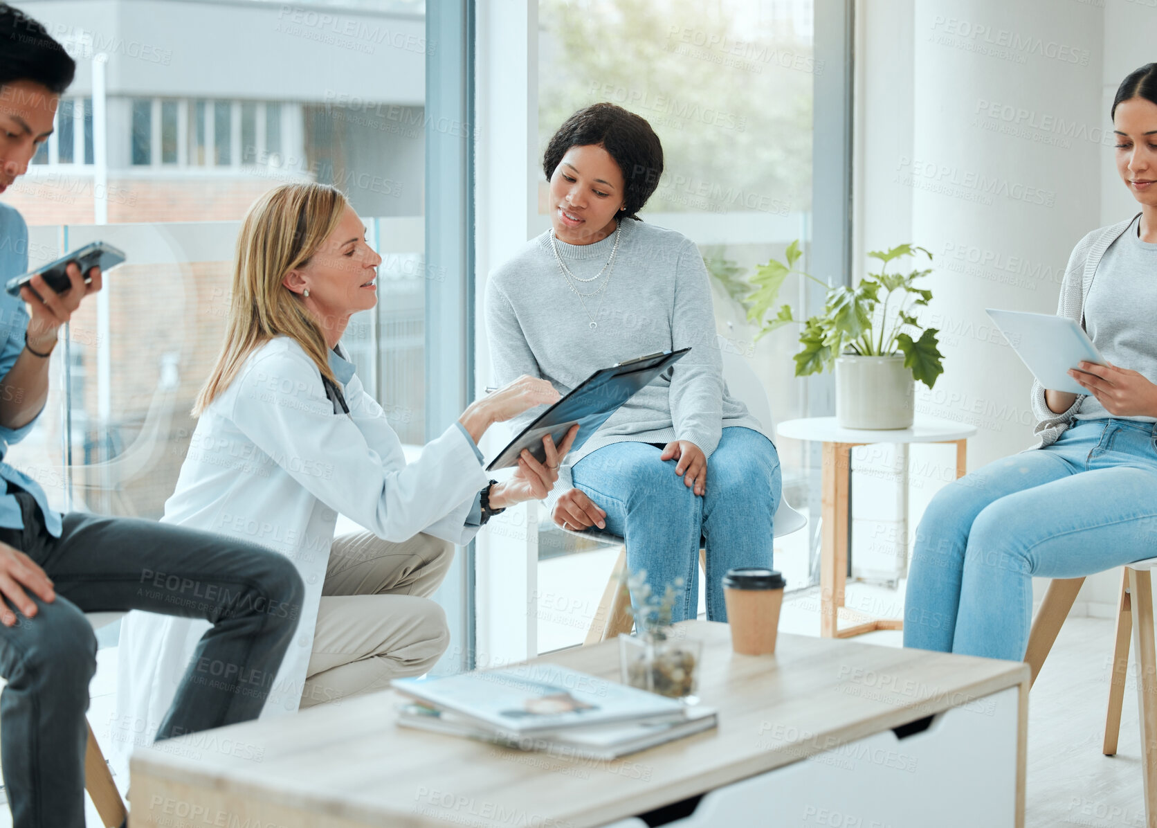 Buy stock photo Shot of a mature doctor and her patient discussing her latest results in the waiting room