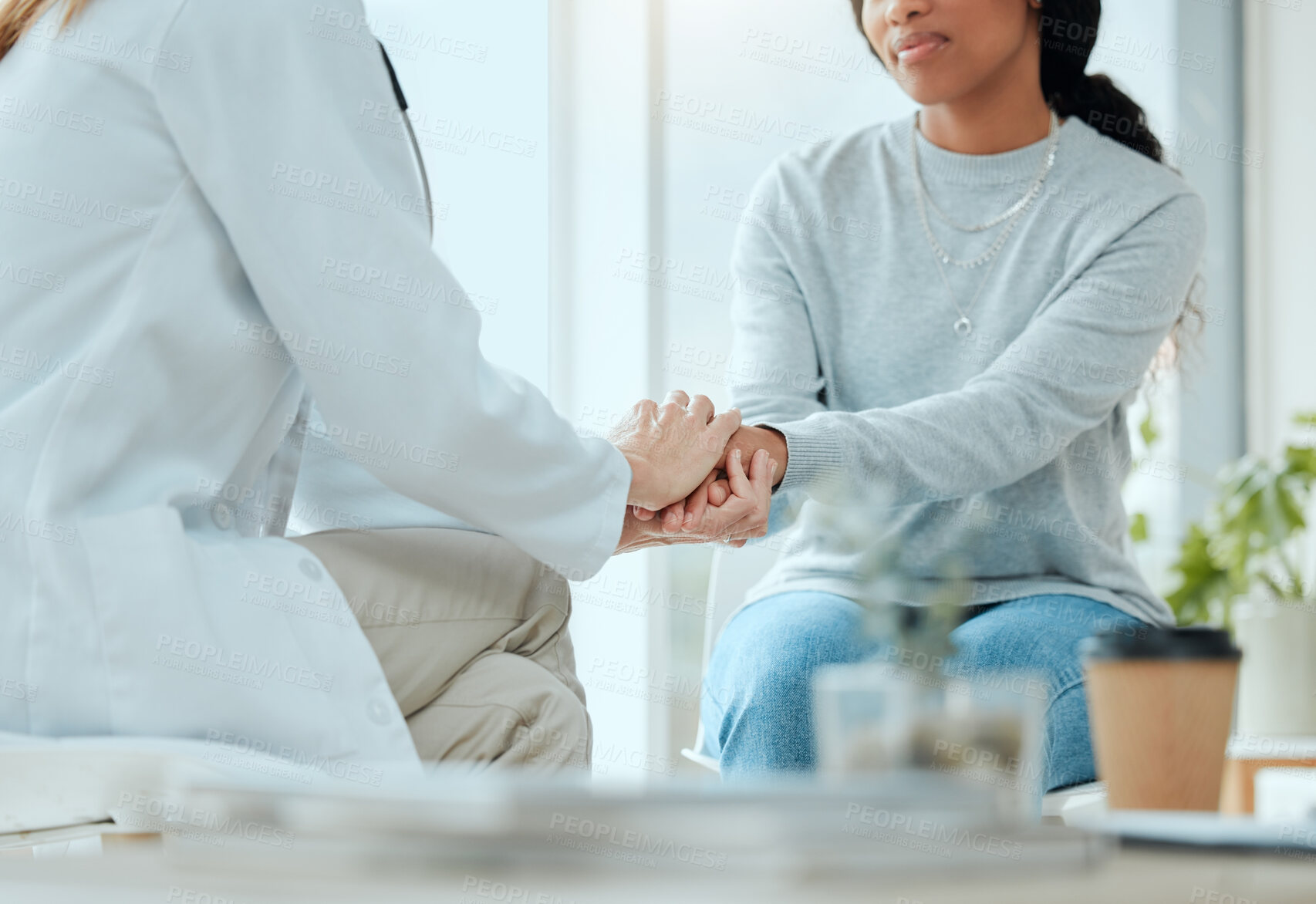 Buy stock photo Holding hands, doctor and patient at hospital on conversation for support, trust snd care. People, medical professional and comfort with feedback or discussion and advice on diagnosis in consultation