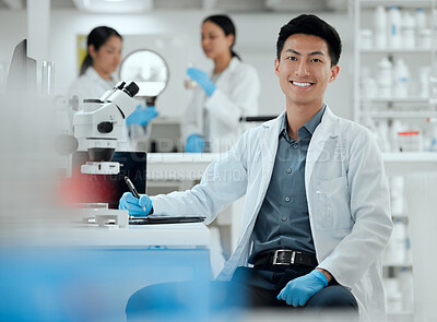 Buy stock photo Shot of a handsome young male scientist in his lab
