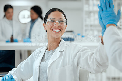 Buy stock photo Shot of two scientists high fiving one another
