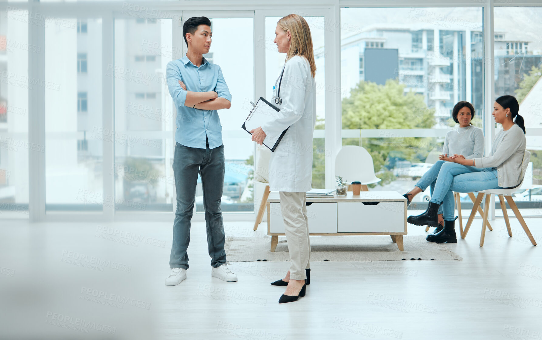 Buy stock photo Shot of a mature doctor and her patient discussing his latest results in the waiting room