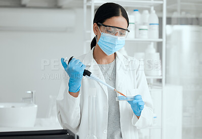 Buy stock photo Shot of a young female scientist inserting a sample into a petri dish
