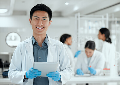 Buy stock photo Shot of a young scientist using a digital tablet