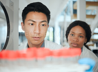 Buy stock photo Scientist, test tube and machine in lab for storage, collaboration and virus with innovation results. Science, people and research for microbiome study, pharmaceutical and biotechnology experiment