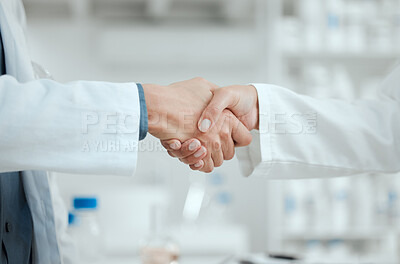 Buy stock photo Shot of two scientists shaking hands in greeting