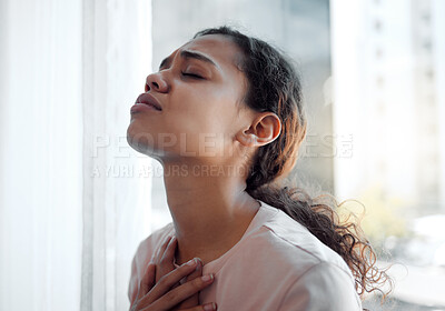 Buy stock photo Shot of a young female experiencing internal turmoil at home