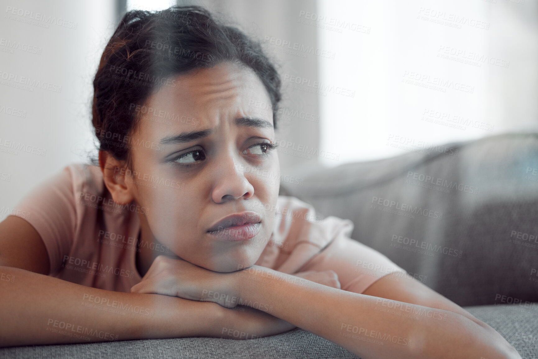 Buy stock photo Shot of a young female experiencing internal turmoil at home