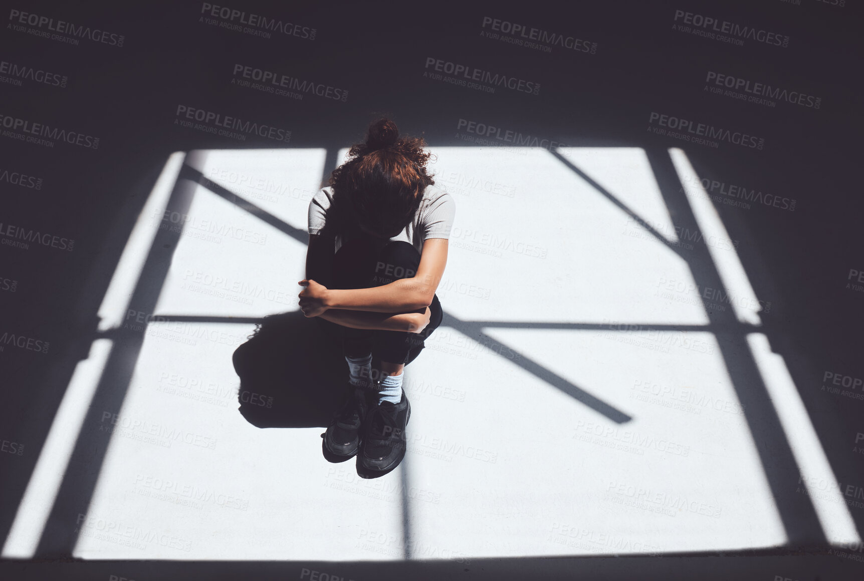 Buy stock photo Woman, window and light with depression in asylum above for abuse, mental illness or psychiatric ward. Top view, female person or patient crying for pain, trauma or anxiety of victim in isolation