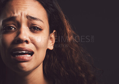 Buy stock photo Sad woman, portrait and crying with trauma for abuse, anxiety or mental illness on a dark studio background. Scared, female person or nervous victim with feeling, emotion or afraid in isolation