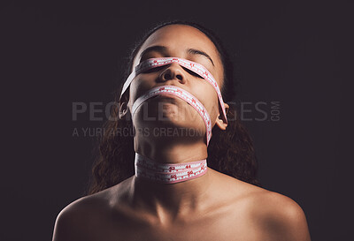 Buy stock photo Measuring tape, risk and person with eating disorder in studio for mental health, psychology and ptsd illness. Identity crisis, mockup and body image with woman on black background for mood swing