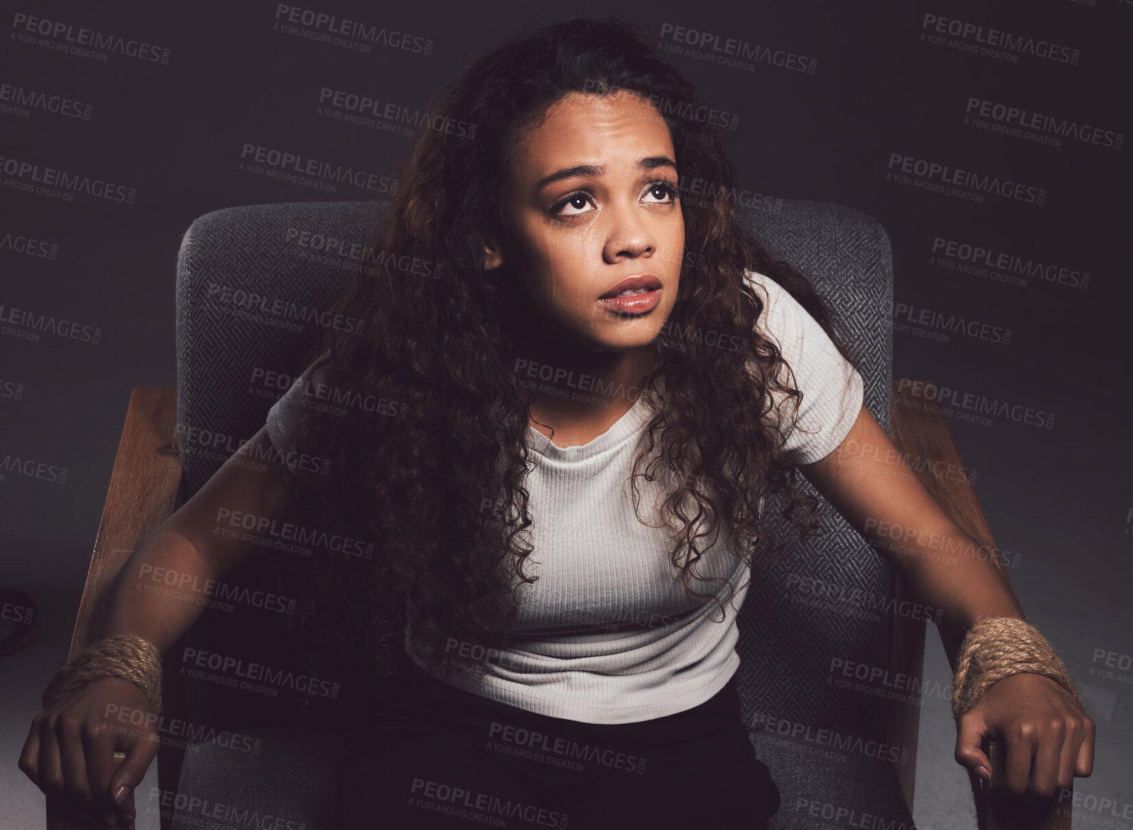 Buy stock photo Woman, hands tied and chair with abuse, fear and anxiety for mental health or bipolar disorder. Female person, struggle and hostage in crying for help in distress, danger or horror on dark background