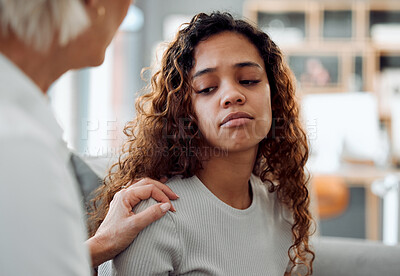 Buy stock photo Shot of an attractive young woman sitting with her psychologist and looking upset during her consultation