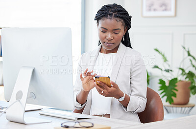 Buy stock photo Black woman, business and typing on phone at a desk for communication, chat and social media. Serious african female entrepreneur reading email on smartphone app with network connection