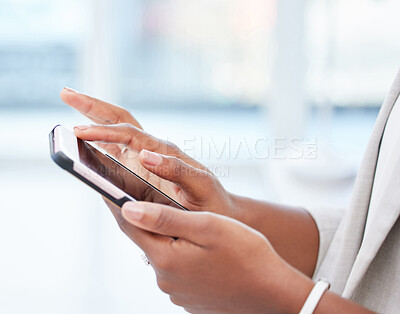 Buy stock photo Shot of an african businesswoman using her smartphone to send a text