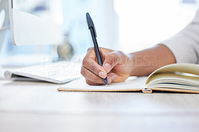 Buy stock photo Shot of a businesswoman making notes in her notebook