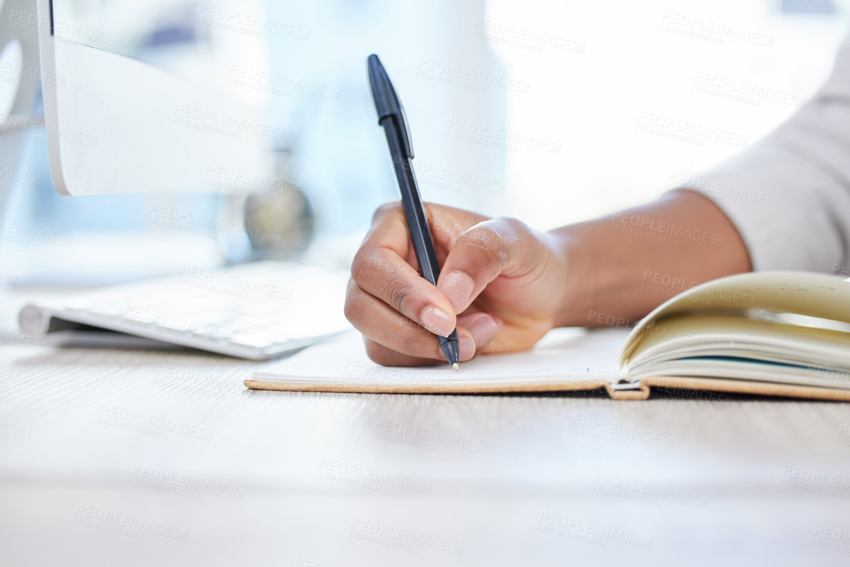 Buy stock photo Pen, notebook and writing at desk for research, closeup and hand for planning in office. Computer, schedule or reminder with notes for business person, journalist and planner or brainstorm in journal