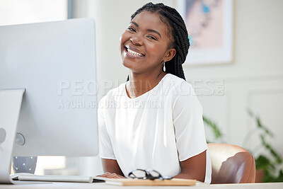 Buy stock photo Shot of a young african businesswoman working on her computer