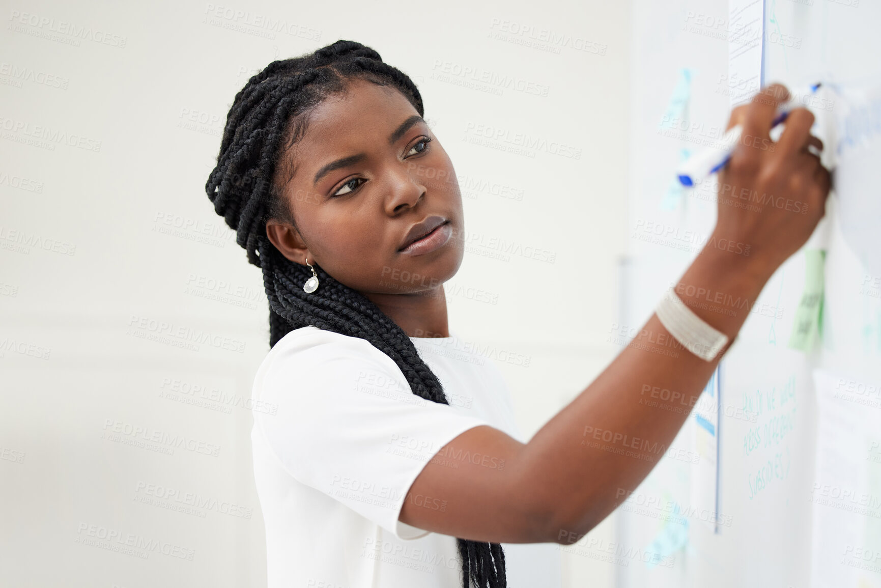 Buy stock photo Planning, whiteboard and businesswoman brainstorming in the office for a corporate startup. Writing, ideas and young professional African female employee working on a company project in the workplace