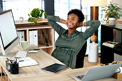 Buy stock photo shot of a young businesswoman relaxing while at work