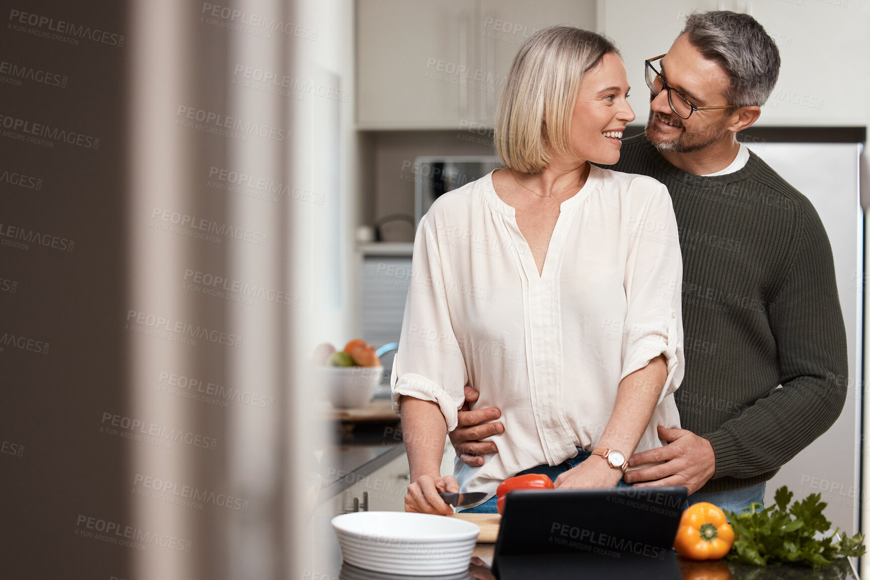 Buy stock photo Shot of a mature couple cooking together at home