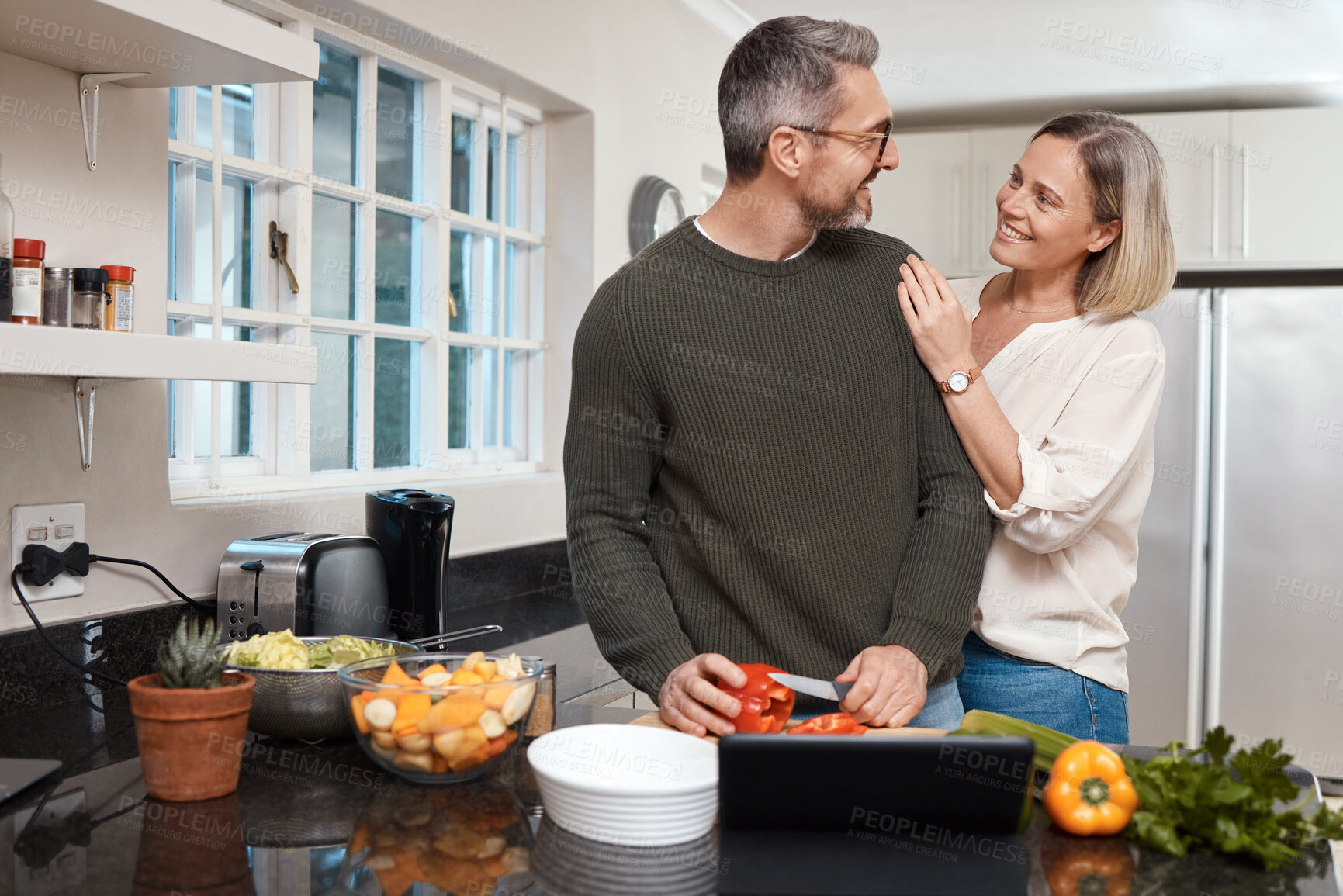 Buy stock photo Shot of a mature couple cooking together at home