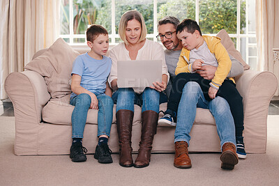 Buy stock photo Shot of a young family bonding while using a laptop on the sofa together at home